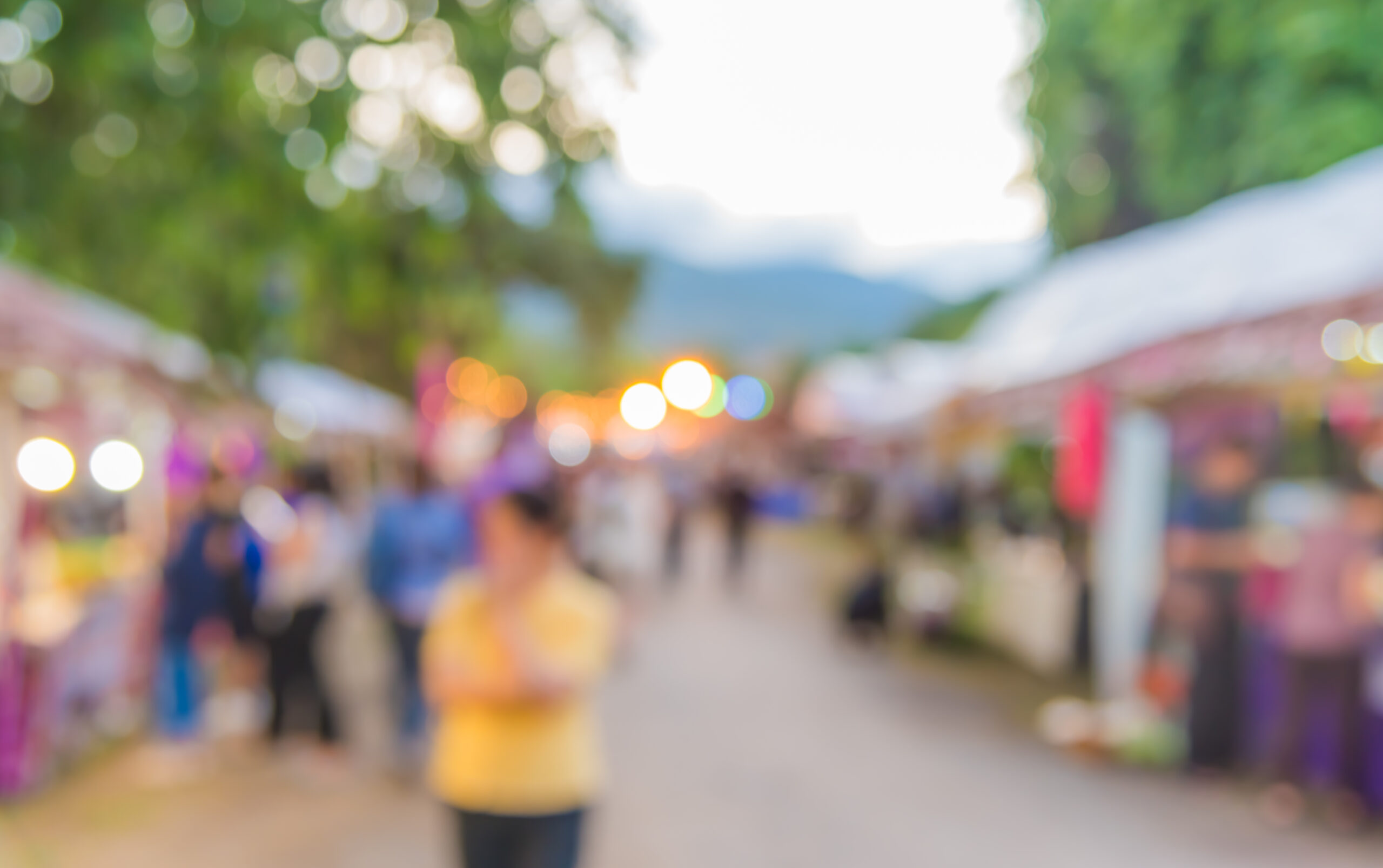 A colorful community event with people walking around.